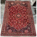 South west Persian red ground Qashgai carpet with central lozenge medallion on geometric field,