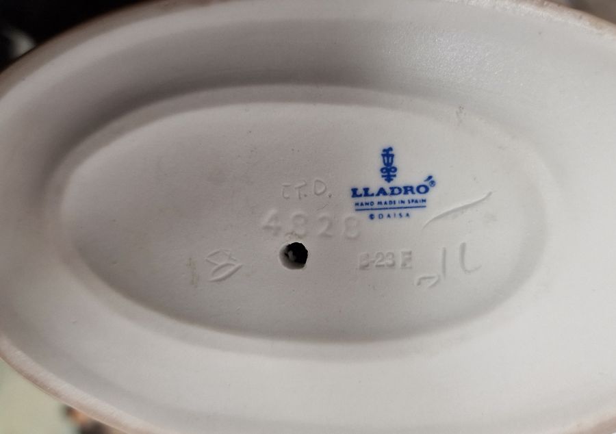 Five Lladro figures including a boy and girl riding a donkey, a pair of girls with baskets of - Image 5 of 10