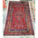 North west Persian red ground Zanjan rug with central hexagonal medallion on field of stylized