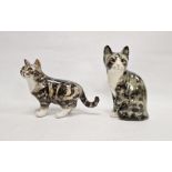 Two Winstanley pottery tabby cats with glass eyes, the first model seated, its tail wrapped around