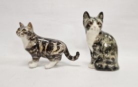 Two Winstanley pottery tabby cats with glass eyes, the first model seated, its tail wrapped around