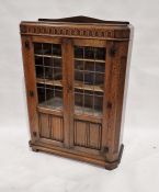 Early 20th century oak display cabinet with pair of astragal-glazed doors enclosing four shelves,