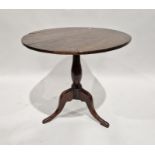 19th century mahogany tilt-top table, the circular top on turned baluster pedestal and tripod