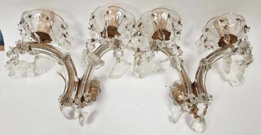 Pair of 20th century glass two-light wall sconces each with petal-shaped drip pans suspending