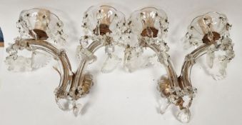 Pair of 20th century glass two-light wall sconces each with petal-shaped drip pans suspending