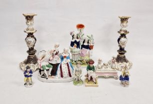Two English porcelain mid-19th century rocaille moulded blue ground candlesticks, painted with
