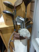 Assorted antique golf clubs in case