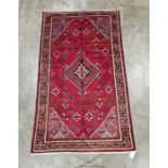 Central Persian red ground Josheghan rug with central geometric medallion in floral field, herati