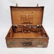 Large leather suitcase with part fitted interior of bottles, brushes, mirrors, etc, with name plaque