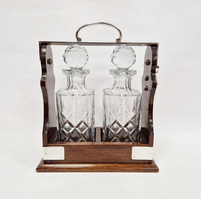 Polished wood and cut glass two bottle tantalus, silver plate mounts, 32cm high Condition