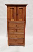 Modern lightwood cupboard with pair panelled doors above four long drawers, on straight supports,