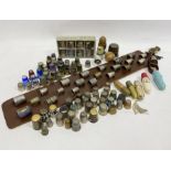 Quantity of assorted thimbles, some silver and silver-coloured metal, wooden, glass, enamel, one