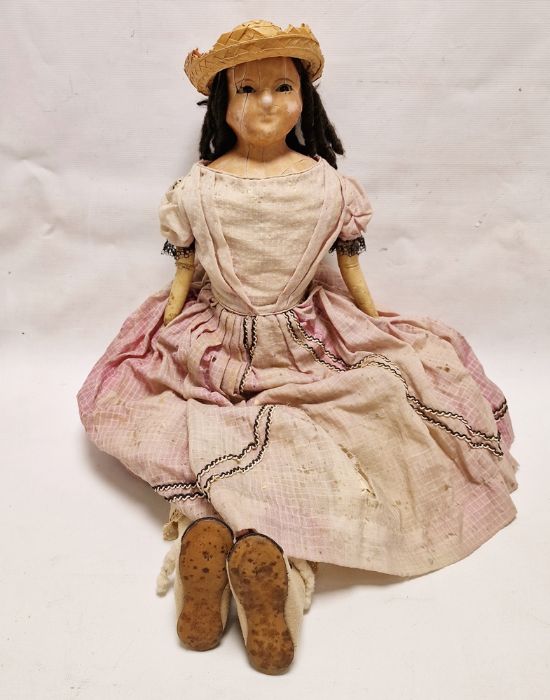 Georgian wax shoulderhead doll with fixed brown glass eyes, cloth body and leather forearms, 76cm