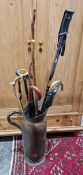 Quantity of walking sticks and a large hammered copper ewer