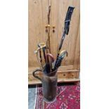 Quantity of walking sticks and a large hammered copper ewer