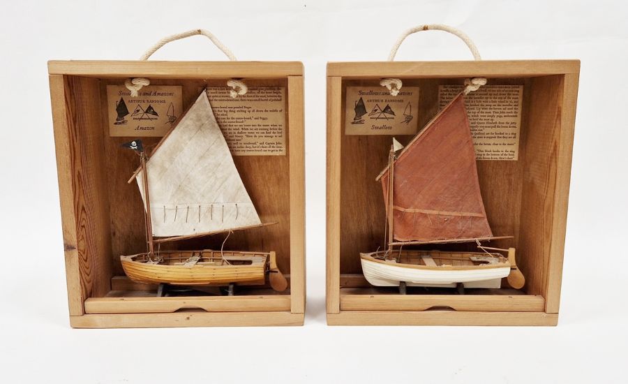 Small wooden model of Arthur Ransome Amazon boat and another of Swallow on wooden stand