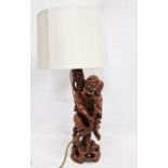 Chinese carved hardwood figural lamp base, 20th century, formed as a man holding on staff, on
