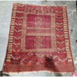 Eastern red ground prayer rug with quartered field, multiple geometric borders 134cm X 118cm