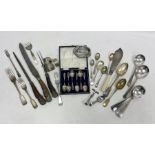 Assorted silver and silver plated flatware to include two silver teaspoons, silver napkin rings
