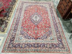 Central Persian Kashan red ground carpet with central floral medallion enclosed by floral pattern,