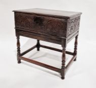 17th century oak bible box on stand with carved panelled front raised on later stand, 65cm wide