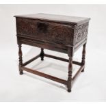 17th century oak bible box on stand with carved panelled front raised on later stand, 65cm wide