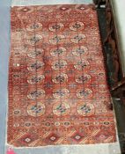Turkoman Tekke red ground rug with three rows of seven quartered elephant foot guls, multiple