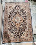 Eastern style red ground rug with central floral medallion on floral field, herati border flanked by