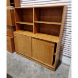 Mid to late 20th century teak wall unit with shelves above sliding cupboards below