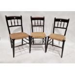 Four ebonised and cane-seated chairs (4)