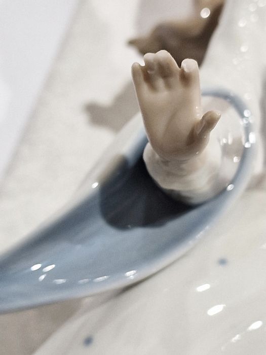 Five Lladro figures including a boy and girl riding a donkey, a pair of girls with baskets of - Image 9 of 10