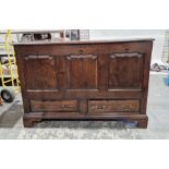 Antique oak mule chest with lift-up lid, having three shaped framed panels to the front, two drawers
