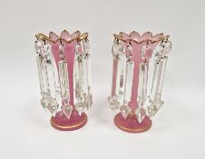 Pair of early 20th century pink glass lustres decorated with gilt banding, 22cm high (2)