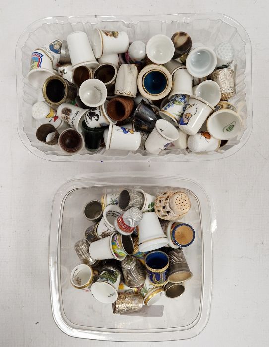 Two boxes of assorted thimbles to include some with images of the Seven Dwarfs from Snow White and
