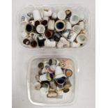 Two boxes of assorted thimbles to include some with images of the Seven Dwarfs from Snow White and