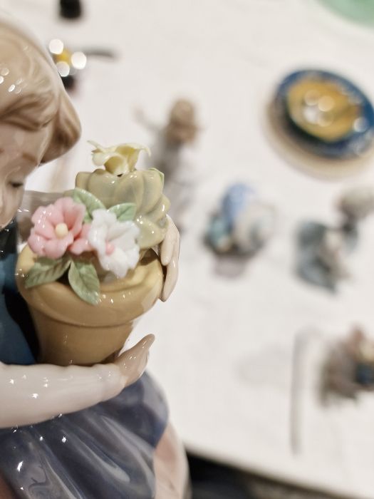 Five Lladro figures including a boy and girl riding a donkey, a pair of girls with baskets of - Image 10 of 10