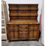 Ercol dark elm dresser with shelved back, cupboards and drawers, 145cm wide