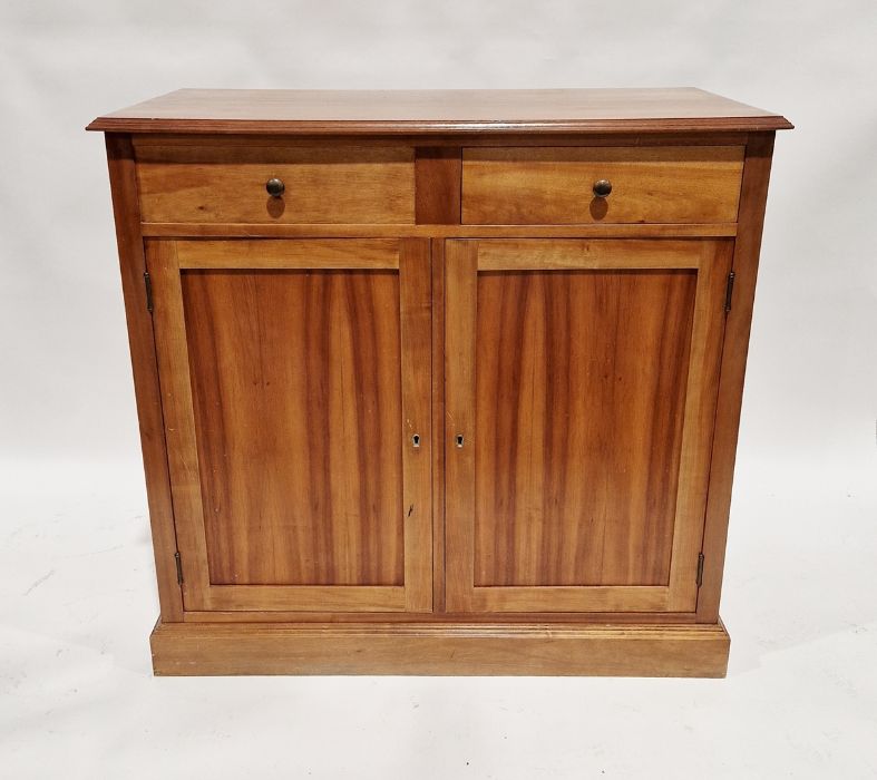 Modern oak sideboard with two drawers (one dummy drawer) above pair of cupboards below, on plinth