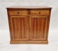 Modern oak sideboard with two drawers (one dummy drawer) above pair of cupboards below, on plinth