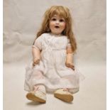 Bisque headed doll marked 'PM' and having blue sleeping eyes, open mouth, composition body, 71cm