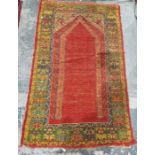 Eastern wool madder ground arched niche rug with multiple floral and geometric borders 185cm x