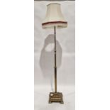 Early 20th century brass standard lamp, with reeded lower section, stepped base raised on square