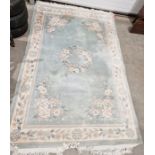 Large Chinese celadon green ground superwash rug with central floral medallion, floral border