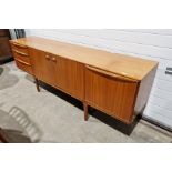 McIntosh teak sideboard with three cupboards and three drawers, on straight supports