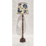 Turned wooden standard lamp with cream shade with blue painted flowers