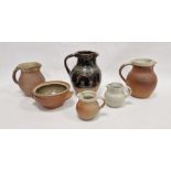 Winchcombe pottery slip-glazed jug, glazed in dark brown and decorated with a band of wave ornament,