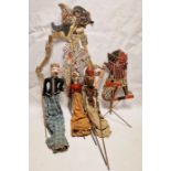 Collection of Far Eastern painted wood puppets with stick operated limbs, a similar flat painted