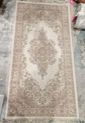 Eastern style cream ground wool pile rug with central floral medallion, multiple herati and floral