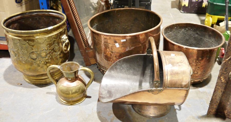 Large brass embossed coal bucket with lion masks and rings on either side, a large copper coal/