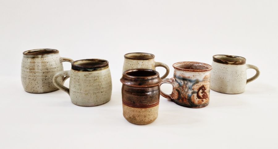 Four studio pottery mugs by the same artist, possibly Andrew Davidson, impressed mark to base,